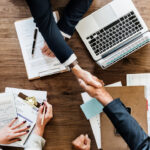 Business people shaking hands together
